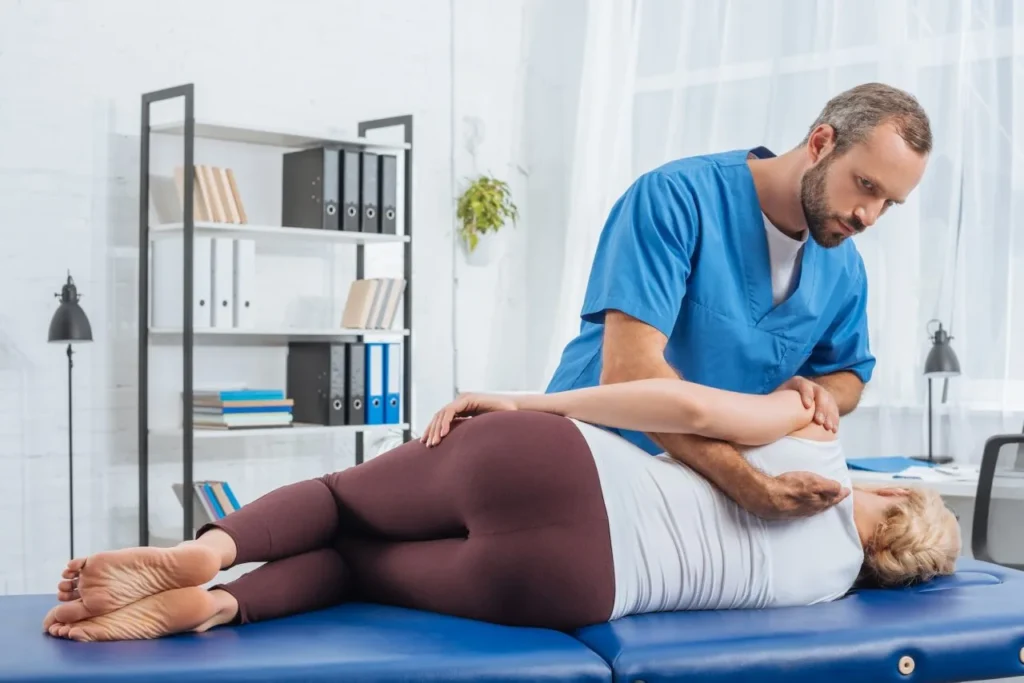 Male osteopathic specialist providing chronic pain management treatment to a female patient at Lavita Osteo clinic in Calgary