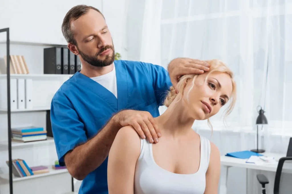 Male rehabilitation therapist guiding a female patient through active rehabilitation exercises at Lavita Osteo clinic in Calgary