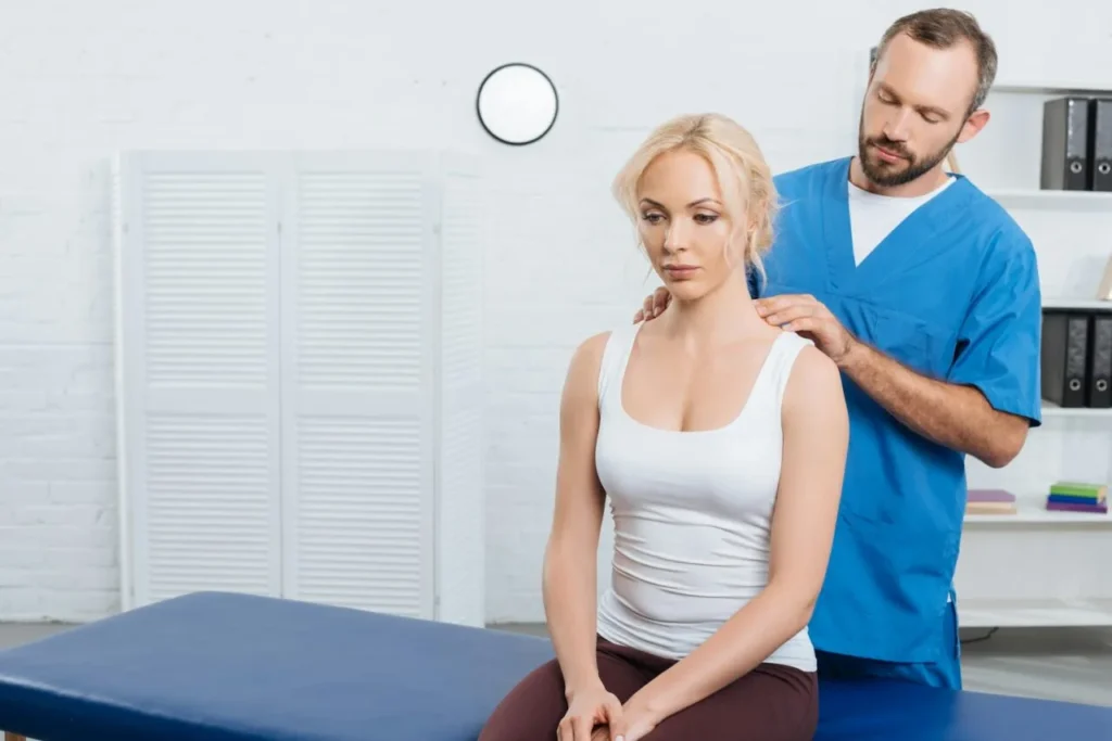 Male therapist providing therapeutic massage and rehabilitation exercises to a female patient at Lavita Osteo clinic in Calgary